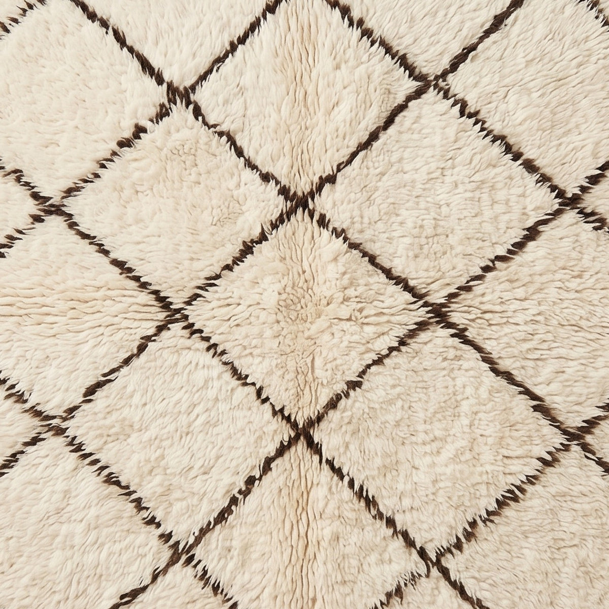 Macro detail of open lattice geometric pattern on ivory Beni Ourain rug