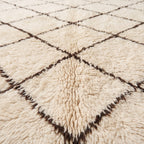 Close-up of thick soft pile and dark brown lattice lines on ivory Beni Ourain rug Ifri