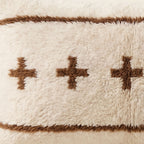 Side view of the Tamazgha Moroccan pillow showing its ivory and brown wool pile