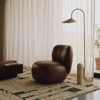 Tinmel ivory, brown and olive Beni Ourain rug styled in a refined living room.
