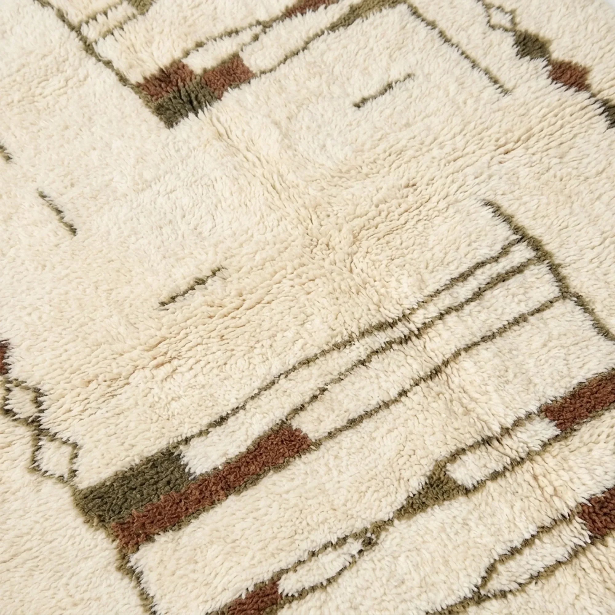Craftsmanship detail of the Tinmel ivory, brown and olive hand-knotted rug.