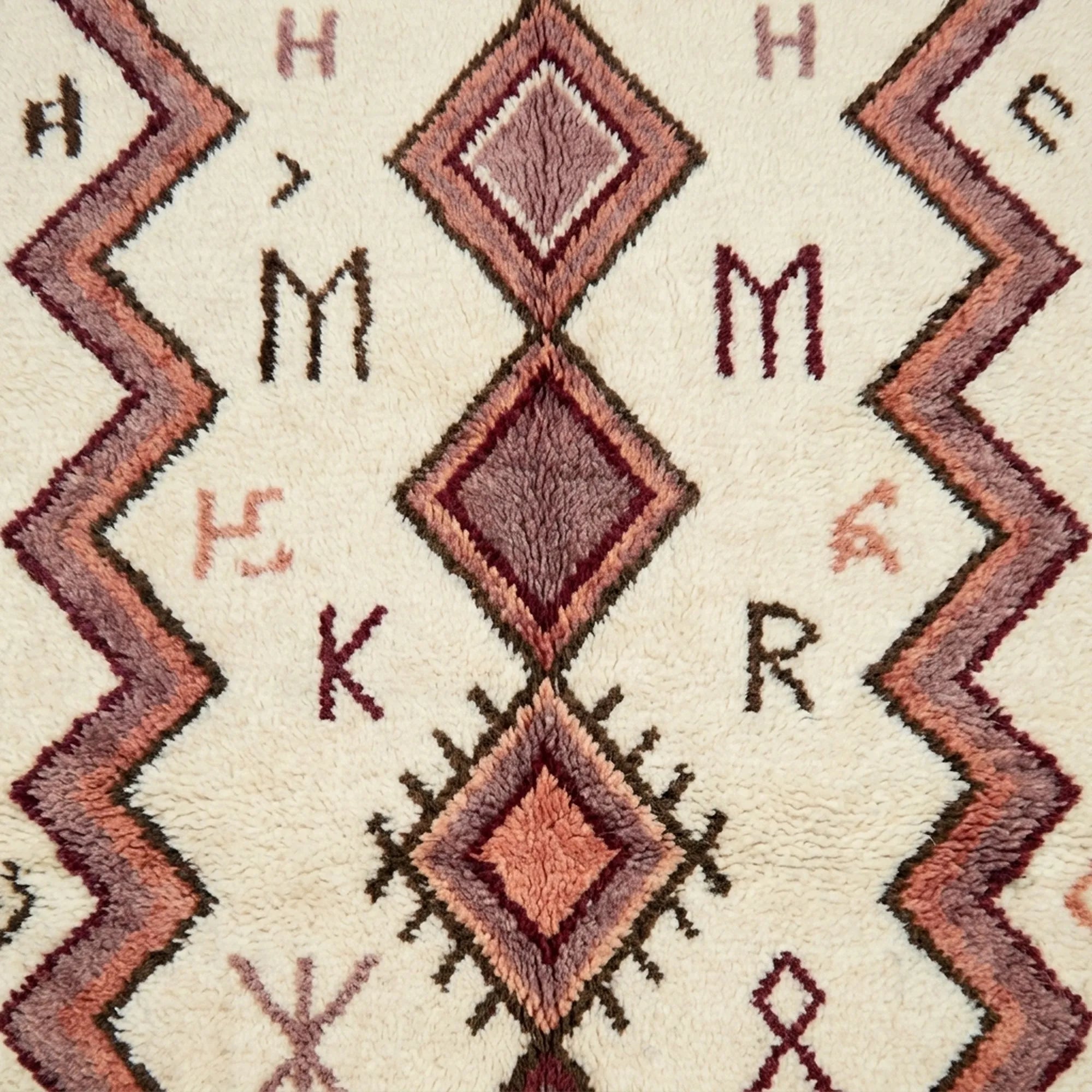 Natural wool texture and burgundy motif detail on the Akalas Azilal rug