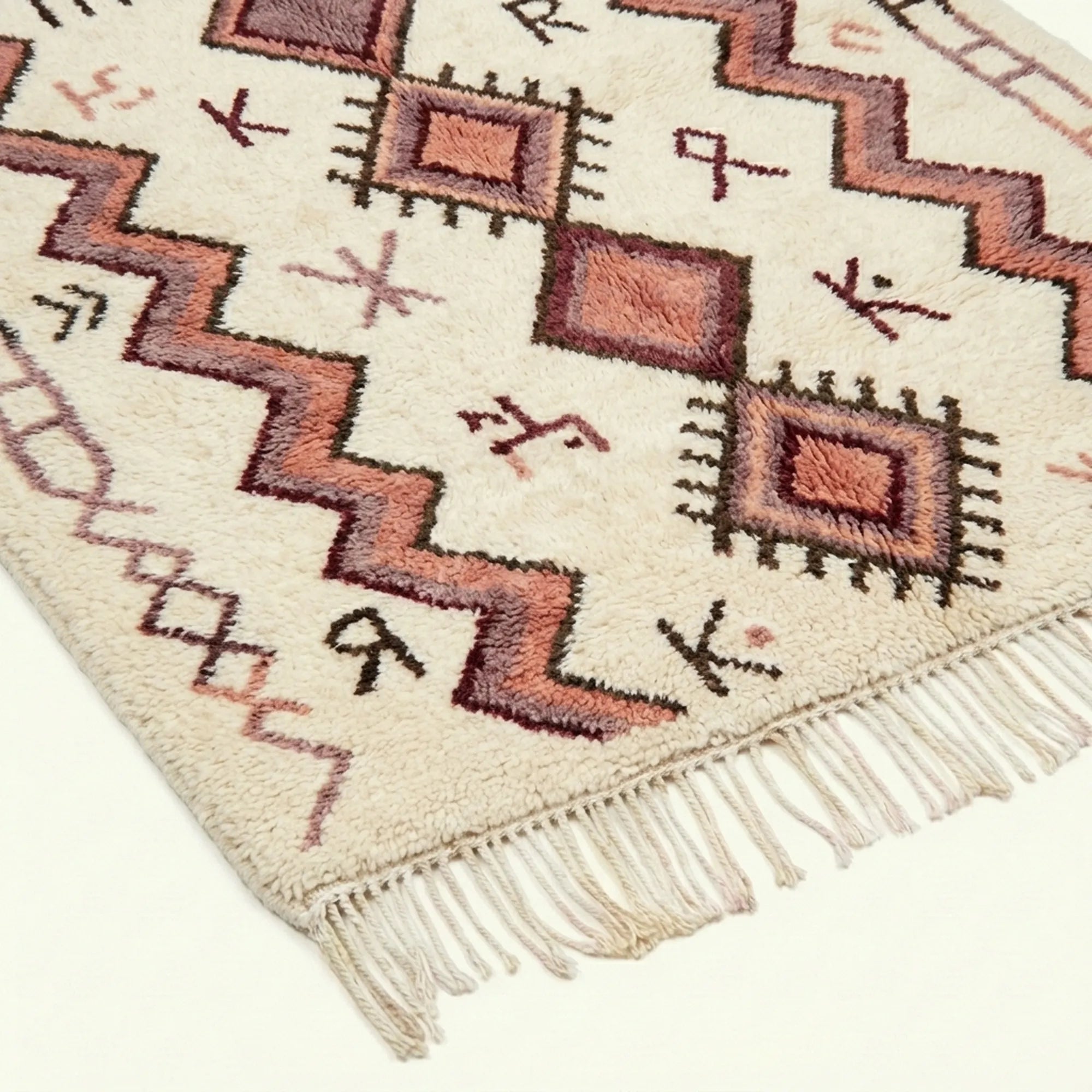 Border and geometric line detail of the ivory and burgundy Akalas Azilal rug