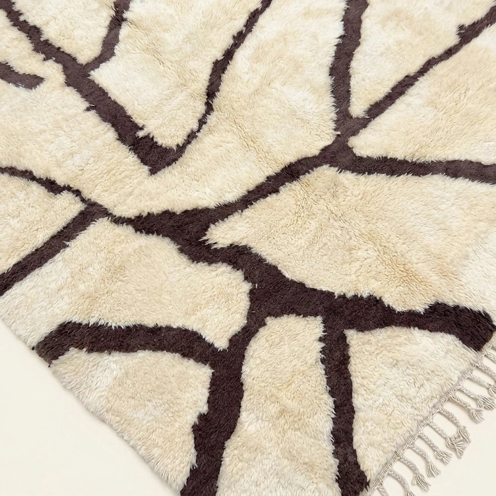 Angled view of the Mazigh ivory and burgundy Beni Ourain rug showing the branch line design.