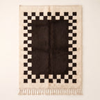 Ivory and charcoal Beni Ourain rug with checkerboard border, full flat view