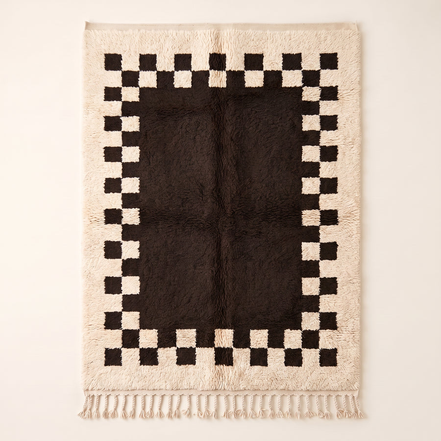 Ivory and charcoal Beni Ourain rug with checkerboard border, full flat view