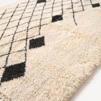 Close-up of Ivory & Charcoal Beni Ourain rug showing thick soft pile and black diamond motifs
