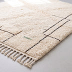 Corner detail showing cream fringe edge and charcoal grid structure