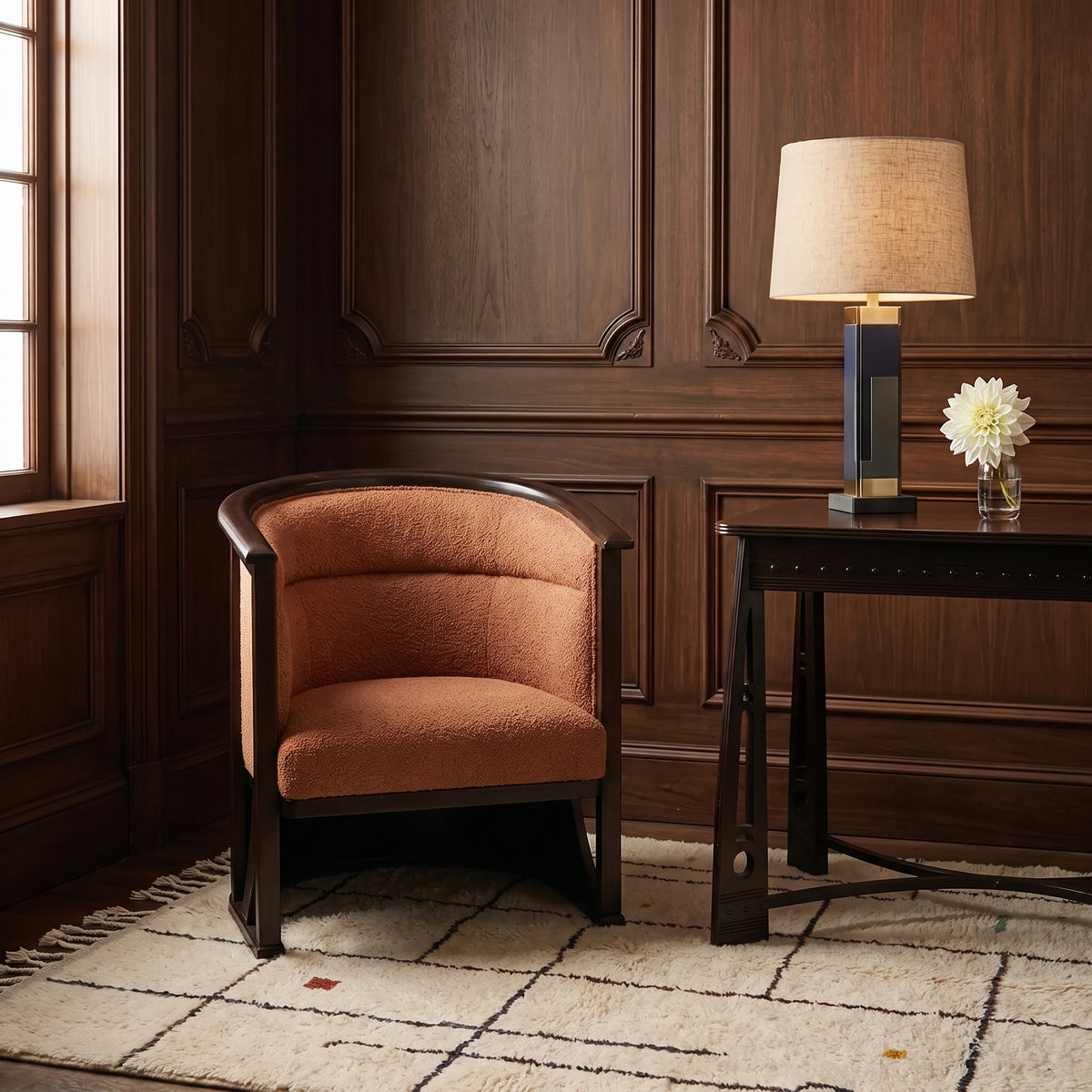 Ivory grid rug styled in a wood-panelled room with terracotta chair and side table