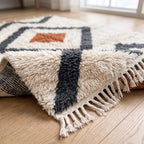 Ivory Beni Ourain rug with charcoal and terracotta diamond pattern in modern living room on wooden floor