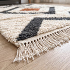 Side view of Beni Ourain rug showing layered diamond design and thick wool pile construction