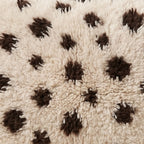 Close-up of the speckle cocoa pattern on the Tazzla Moroccan wool pillow