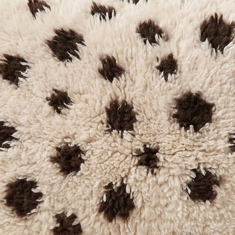 Close-up of the speckle cocoa pattern on the Tazzla Moroccan wool pillow