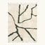 Full view of the Tazla ivory and forest green Beni Ourain rug with a branch line design.