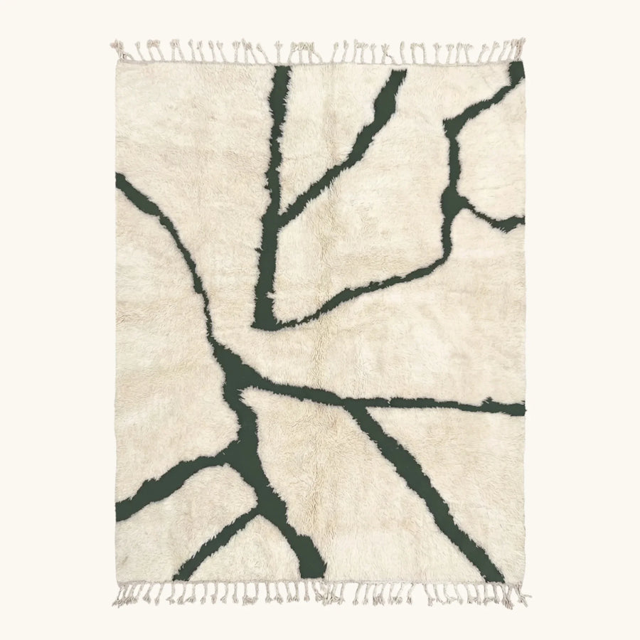 Full view of the Tazla ivory and forest green Beni Ourain rug with a branch line design.