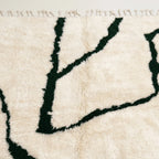 Close-up of the forest green branch line pattern on the Tazla ivory Beni Ourain rug.