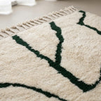 Close-up of the natural Atlas wool pile on the Tazla ivory and forest green Beni Ourain rug.