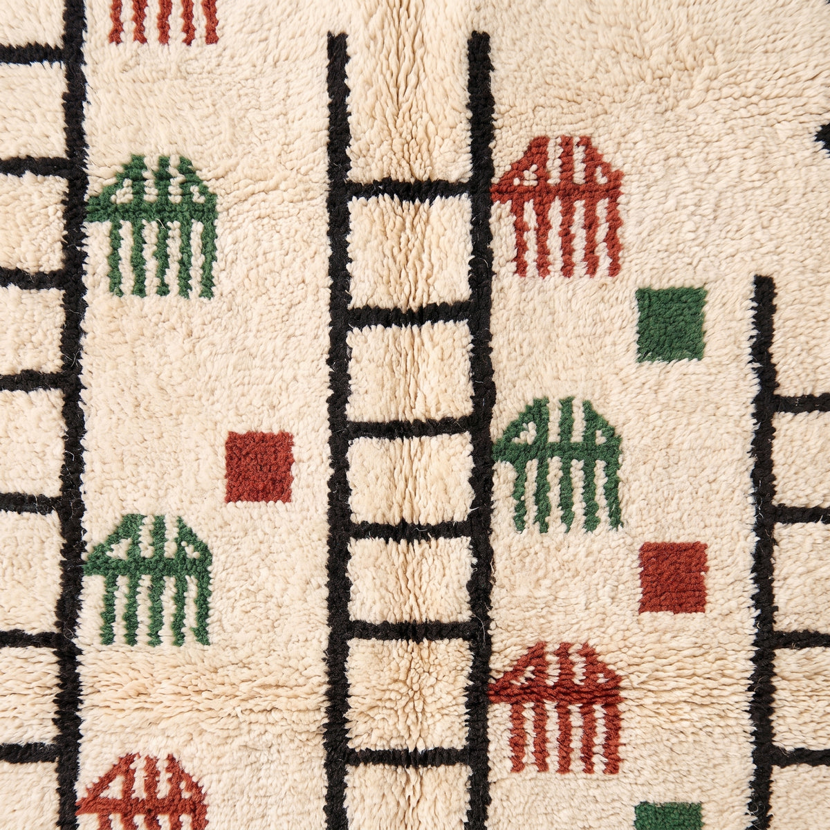 Close-up of rug edge and fringe showing ladder and comb motif detail with ivory fringe trim