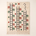 Ivory Beni Ourain rug with black ladder and zigzag motif, terracotta and forest green comb shapes scattered throughout, Ayyur design