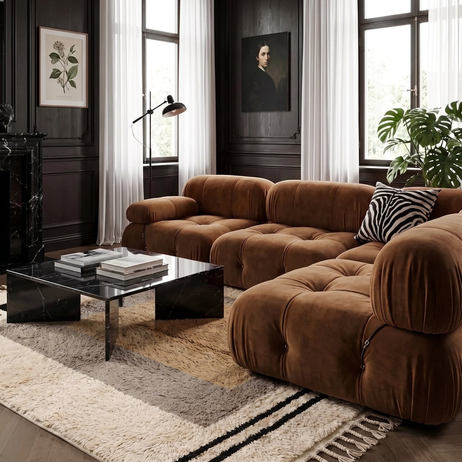 Ivory and grey nested frame Beni Ourain rug layered in modern living room with brown leather sofa and black table