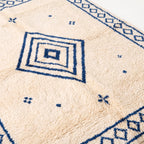 Concentric diamond motif and scattered cross pattern, close-up of pile texture