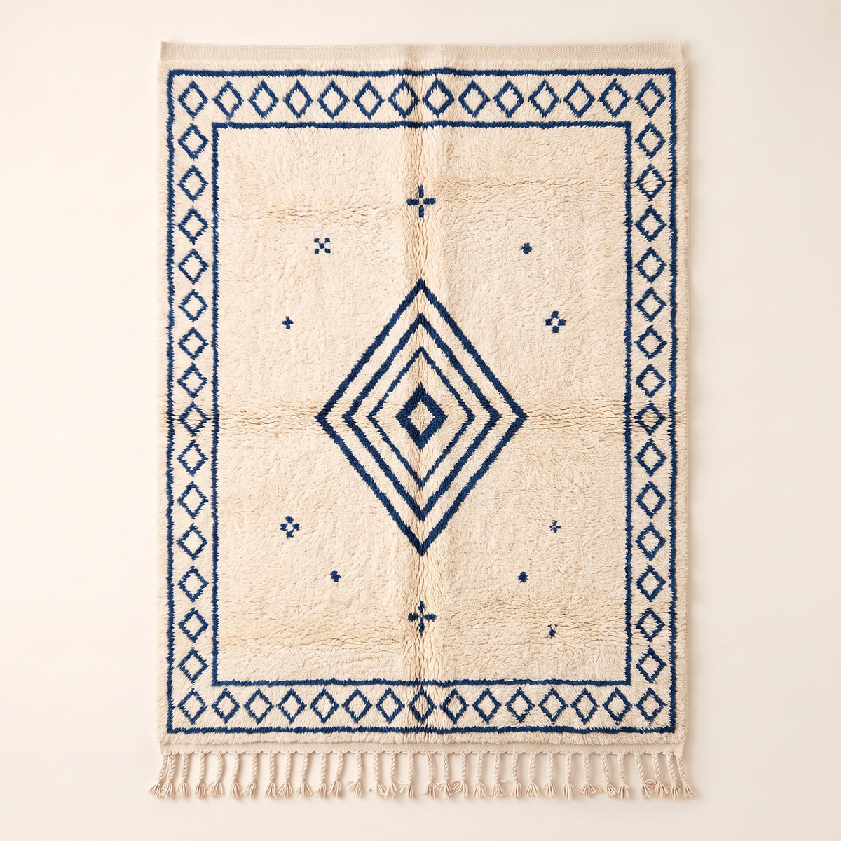 Ivory & Indigo Beni Ourain Rug with concentric diamond design and scattered motifs, flat view