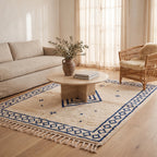 Ivory & Indigo Beni Ourain rug in living room with cream sofa and rattan chair