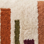 Close-up of the color bars pattern on the Tiddukla Moroccan wool pillow