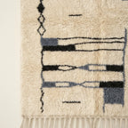 Close-up of the abstract linear pattern on the Amun rug.
