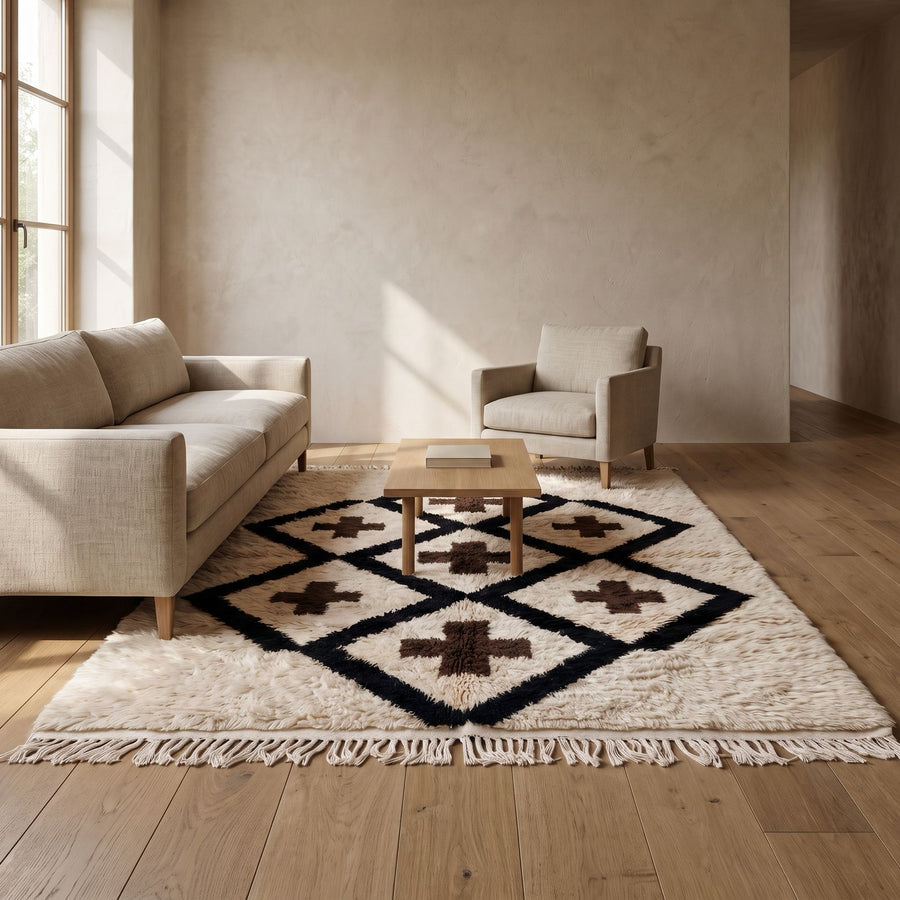 Ivory, navy and brown Beni Ourain rug in modern living room with beige sofa and furniture