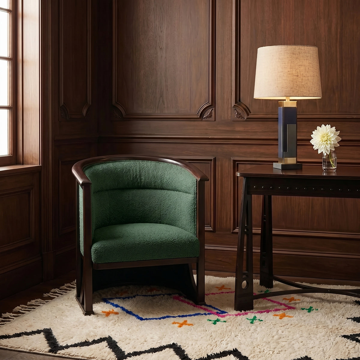 Ivory Azilal rug with diamond pattern layered in a wood-paneled room beneath a green chair and dark desk