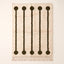 Ivory and olive Beni Ourain rug with five lollipop rail motifs featuring dark olive circles at top and bottom connected by thin vertical rails on cream ground, flat lay on plain background