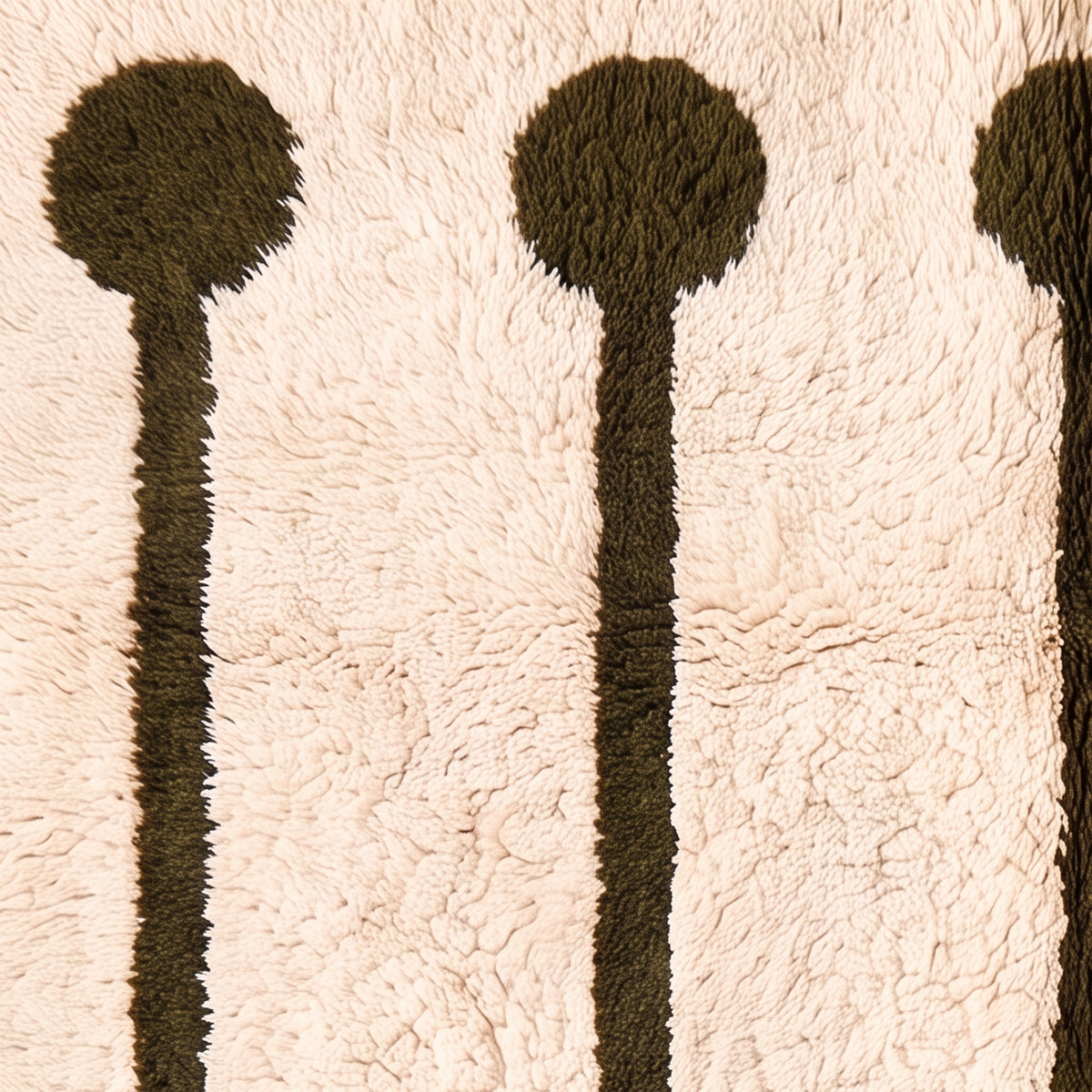 Close-up texture of ivory and olive Beni Ourain rug showing hand-knotted wool pile and lollipop rail construction