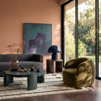 Ivory and olive Beni Ourain lollipop rails rug in modern living room with terracotta walls, grey sofa, olive armchair and round side table