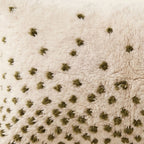 Side view of the Tizi Moroccan pillow showing its ivory and olive wool pile