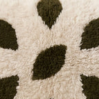 Close-up of the olive petals pattern on the Ijjeg Moroccan wool pillow