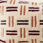 Side view of the Iggi Moroccan pillow showing its ivory, plum and black wool pile