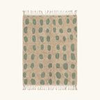 Full view of the Taddart ivory and sage green Beni Ourain rug with an oval grid design.