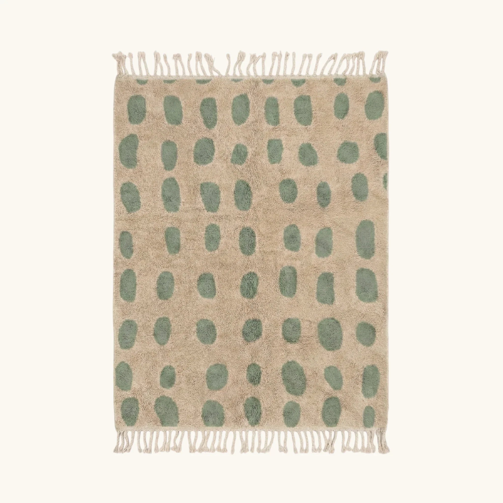 Full view of the Taddart ivory and sage green Beni Ourain rug with an oval grid design.