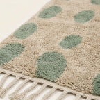 Close-up of the sage green oval grid pattern on the Taddart ivory Beni Ourain rug.