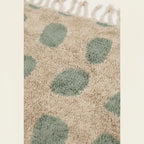 Fringe and edge detail of the Taddart ivory and sage green Beni Ourain rug.