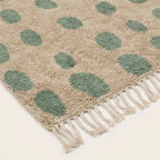 Additional angled view of the Taddart ivory and sage green Beni Ourain rug.