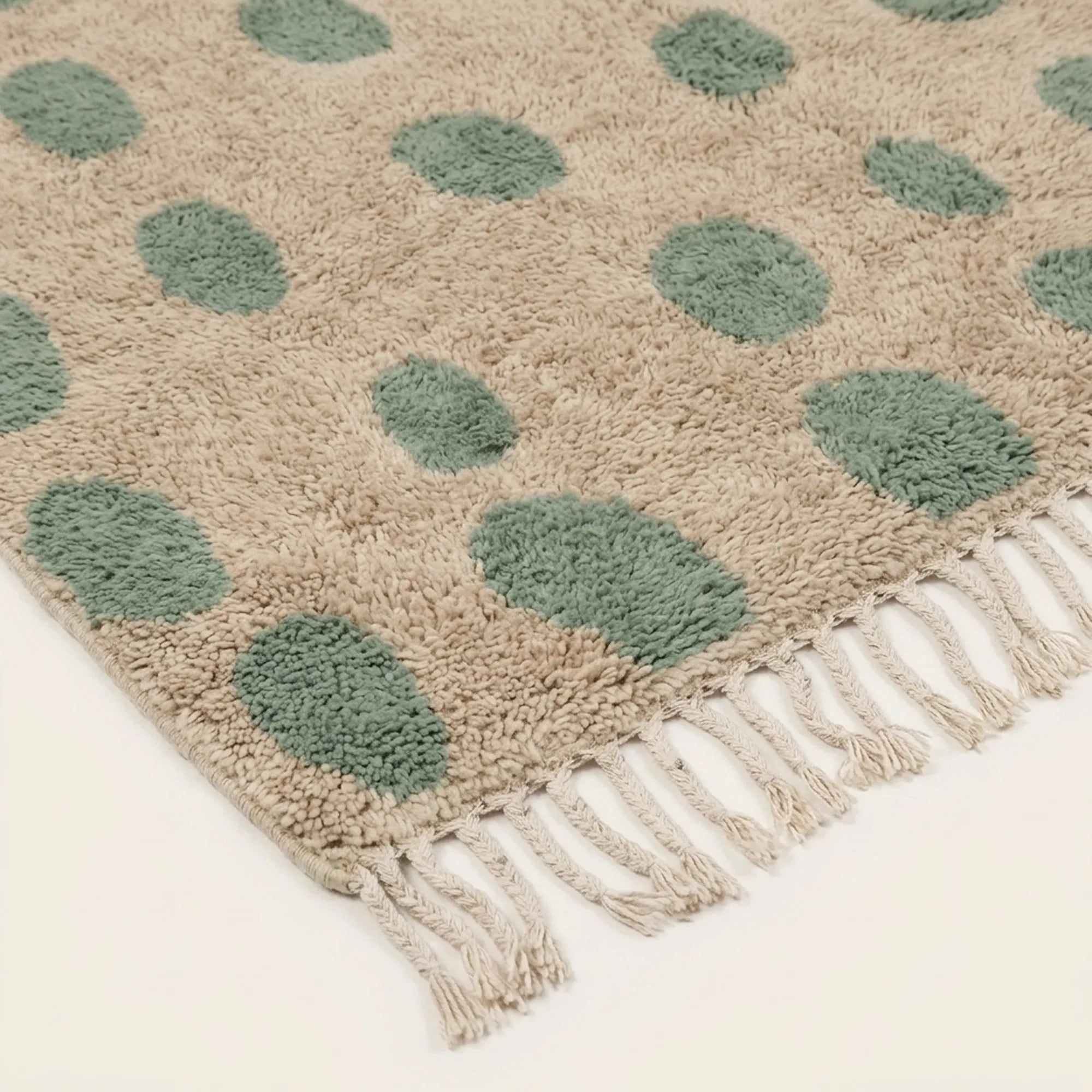Additional angled view of the Taddart ivory and sage green Beni Ourain rug.