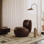 Targa ivory, taupe and olive Beni Ourain rug styled in a refined living room.