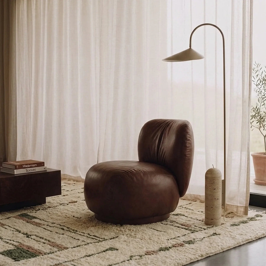 Targa ivory, taupe and olive Beni Ourain rug styled in a refined living room.