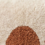 Close-up of the half moon pattern on the Ayyur Moroccan wool pillow