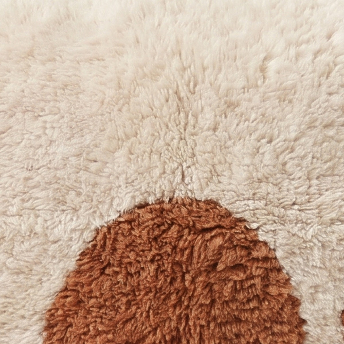 Close-up of the half moon pattern on the Ayyur Moroccan wool pillow