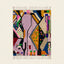 Full view of the Tamsa Boujaad rug in lilac, mustard, black, green and pink with angular abstract color-block forms