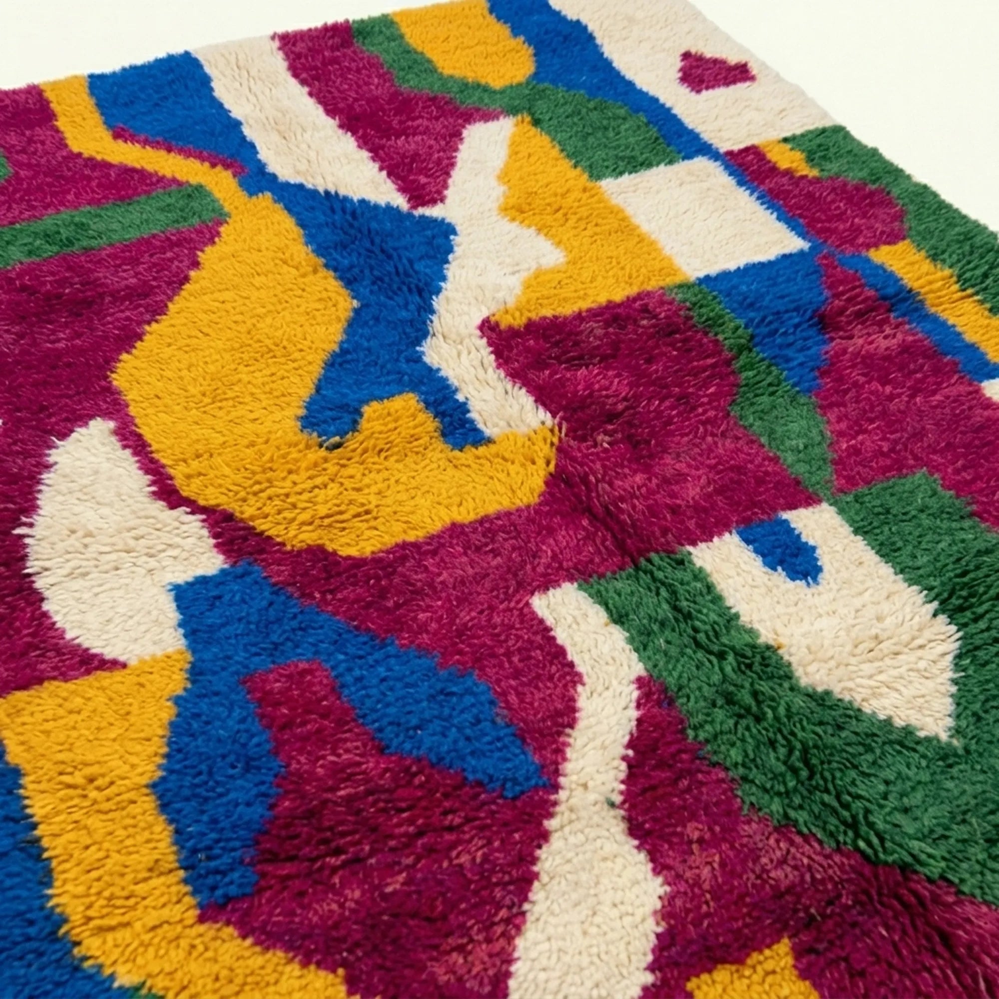 Pattern close-up of Amzagh showing bold magenta, cobalt, mustard and green abstract ribbon forms