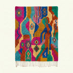 Full view of the Awrir magenta, turquoise and saffron Boujaad rug with a flowing abstract diamond design.